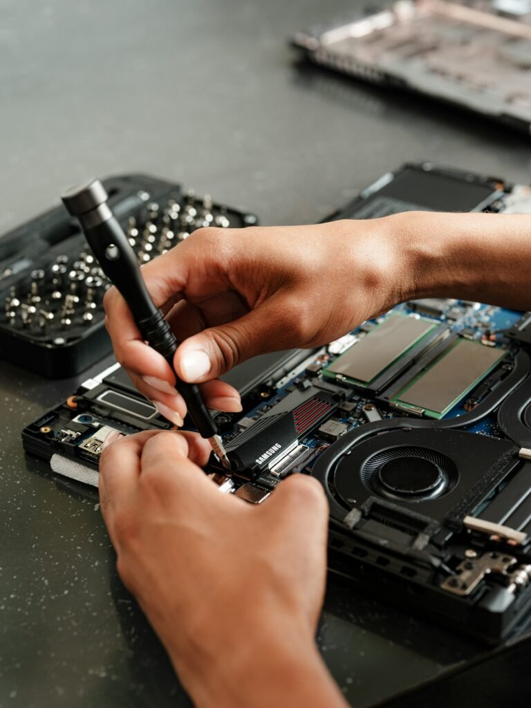 A person working on a piece of electronics
