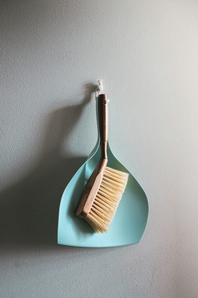Brown wooden brush on white wall