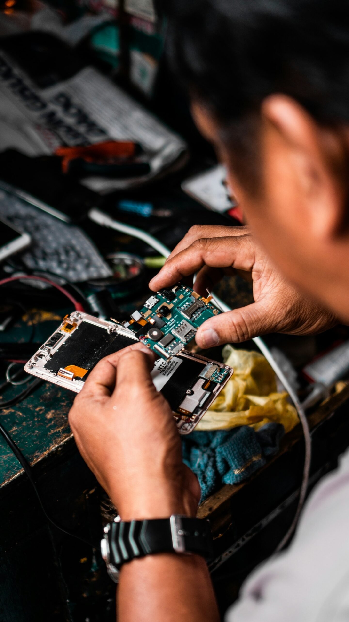 Phone with a cracked screen being repaired - right to repair UK phones